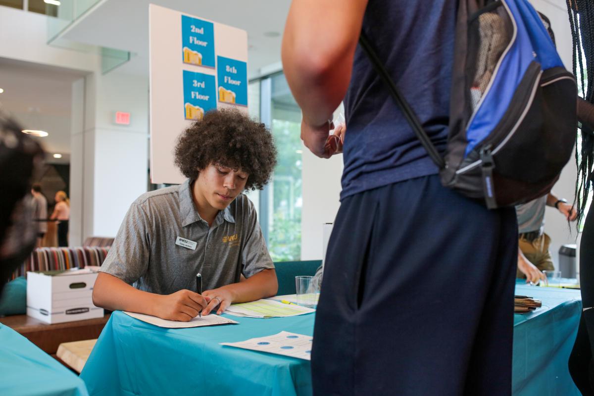 RA Corey Jackson signs in students at GRC.