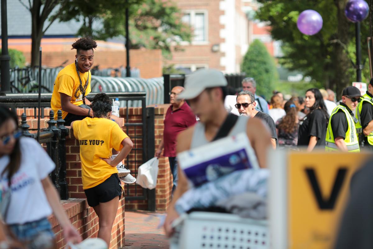 Students, family members and volunteers outside Rhoades Hall during freshman move-in on Saturday. 