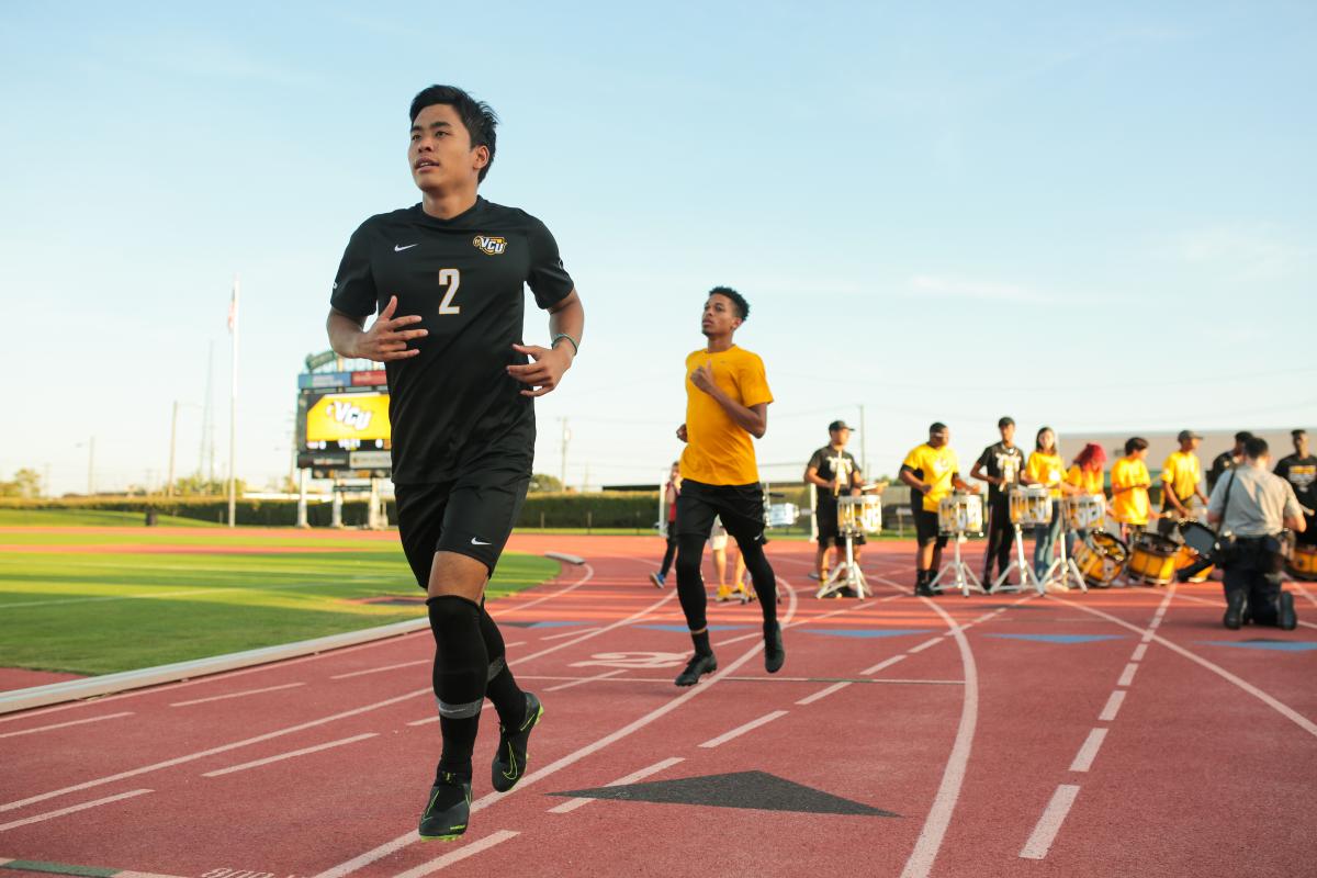 Senior defender Ryo Shimazaki runs onto the field from the locker room before the match. Photo by Jon Mirador
