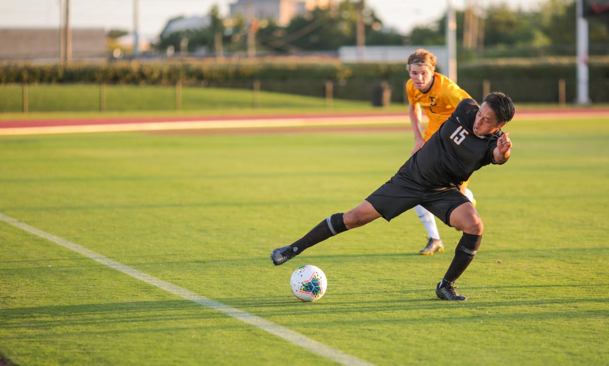 Junior midfielder Toranosuke Abe stretches for the ball near the sideline in the first half against ETSU. Photo by Jon Mirador