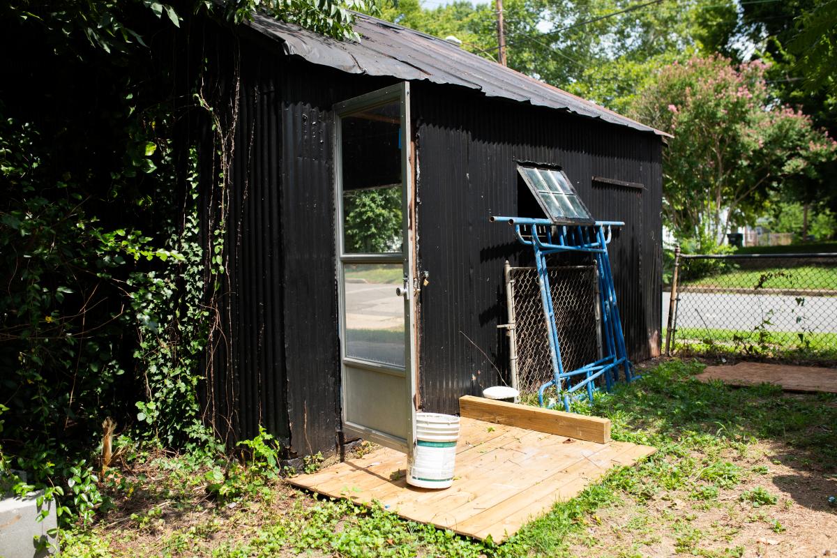 Noah Hook says he found paint buckets, tools and a king-size mattress while cleaning the neglected shed. Photo by Jon Mirador
