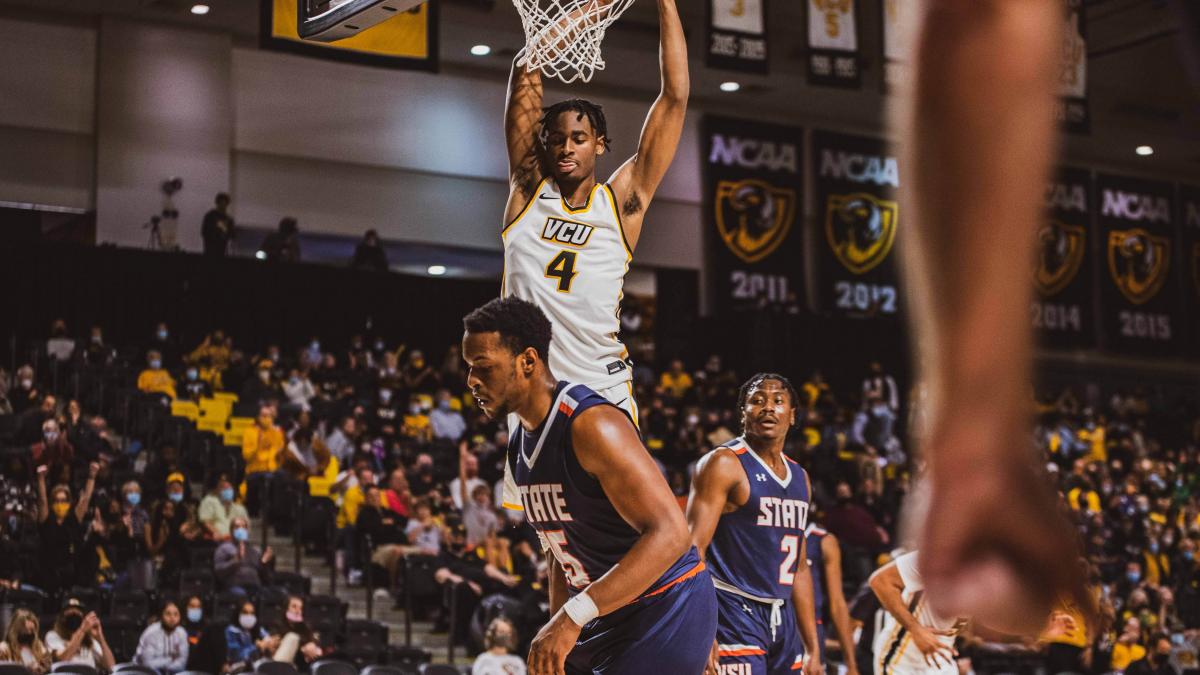Men's basketball player, and freshman guard Jalen DeLoach, dunks during an exhibition game against Virginia State University. Photo by Megan Lee